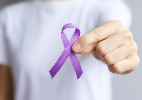 DV purple ribbon held by hand